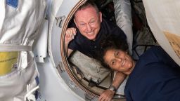 In this photo provided by NASA, Boeing Crew Flight Test astronauts Butch Wilmore, left, and Suni Williams pose for a portrait inside the vestibule between the forward port on the International Space Station's Harmony module and Boeing's Starliner spacecraft on June 13, 2024. (NASA via AP)