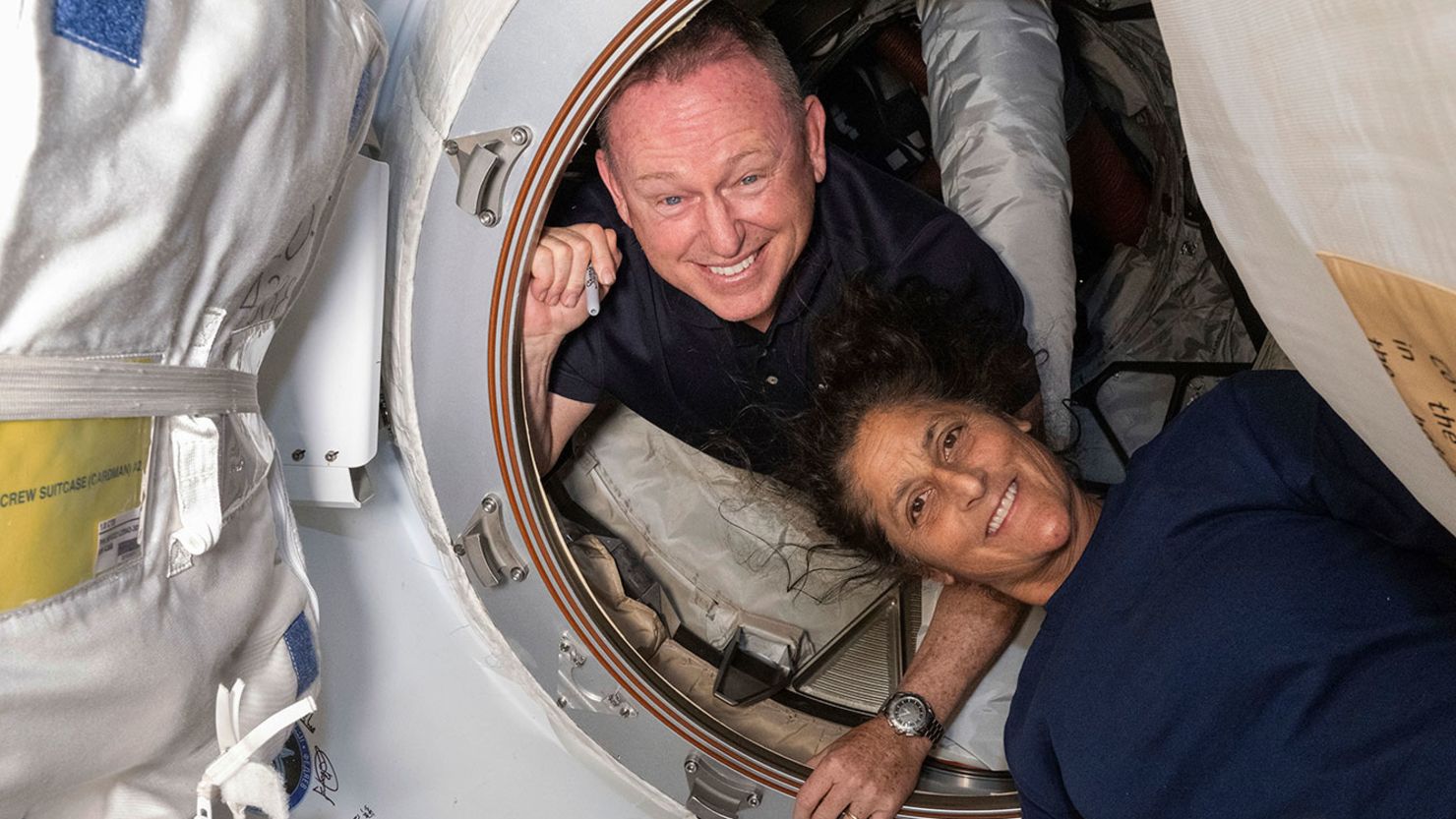 In this photo provided by NASA, Boeing Crew Flight Test astronauts Butch Wilmore, left, and Suni Williams pose for a portrait inside the vestibule between the forward port on the International Space Station's Harmony module and Boeing's Starliner spacecraft on June 13, 2024.