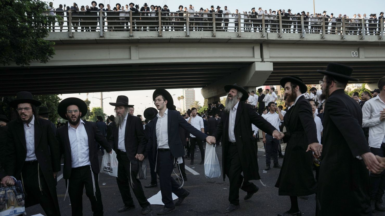 Ultra-Orthodox Jewish men block a highway during a protest against army recruitment in Bnei Brak, Israel, on June 27, 2024.