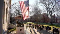 FILE - People take photos near a John Harvard statue, left, on the Harvard University campus, Jan. 2, 2024, in Cambridge, Mass. Two task forces charged with proposing ways to combat anti-Muslim, anti-Arab, and anti-Palestinian bias and antisemitism at Harvard University have delivered their preliminary recommendations to Harvard interim president Alan Garber. (AP Photo/Steven Senne, File)