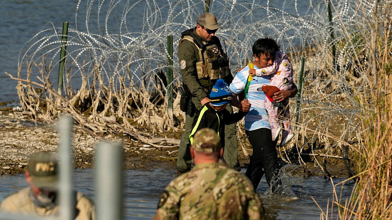 FILE - Migrants are taken into custody by officials at the Texas-Mexico border, Jan. 3, 2024, in Eagle Pass, Texas. A federal judge on Friday, June 28, 2024, approved the Biden administration’s request to partially end a nearly three-decade-old agreement to provide court oversight of how the government cares for migrant children in its custody. (AP Photo/Eric Gay, file)