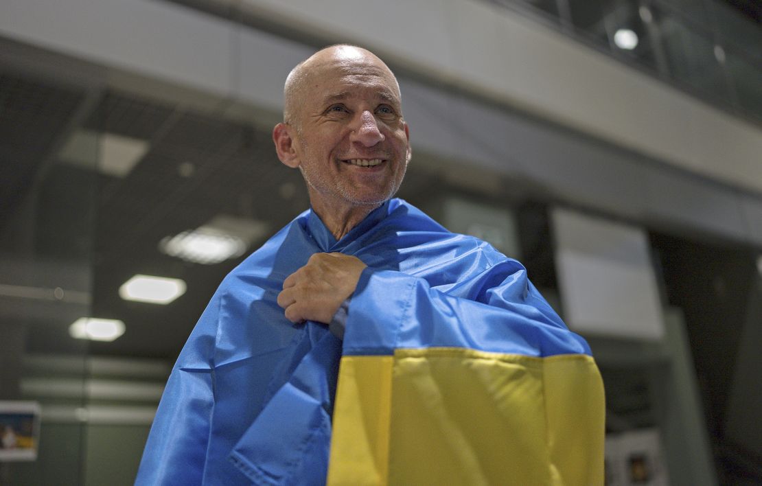 Bohdan Heleta, a priest who was detained inside his own Ukrainian Greek Catholic Church in the occupied city of Berdiansk in 2022, smiles at Kyiv airport on June 29, 2024, after he was freed in a prisoner swap.