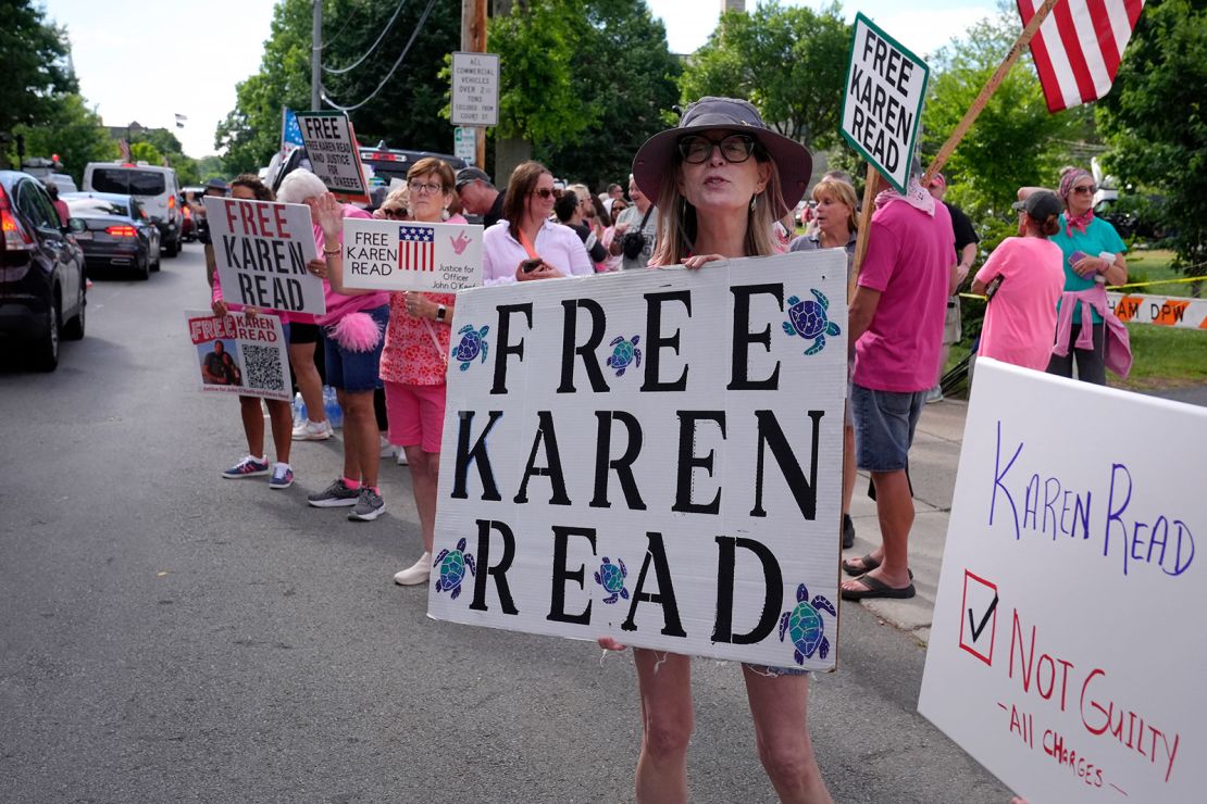 Jean Allan, a supporter of Karen Read, displays a sign to passing cars outside Norfolk Superior Court on July 1, 2024, in Dedham, Massachusetts.