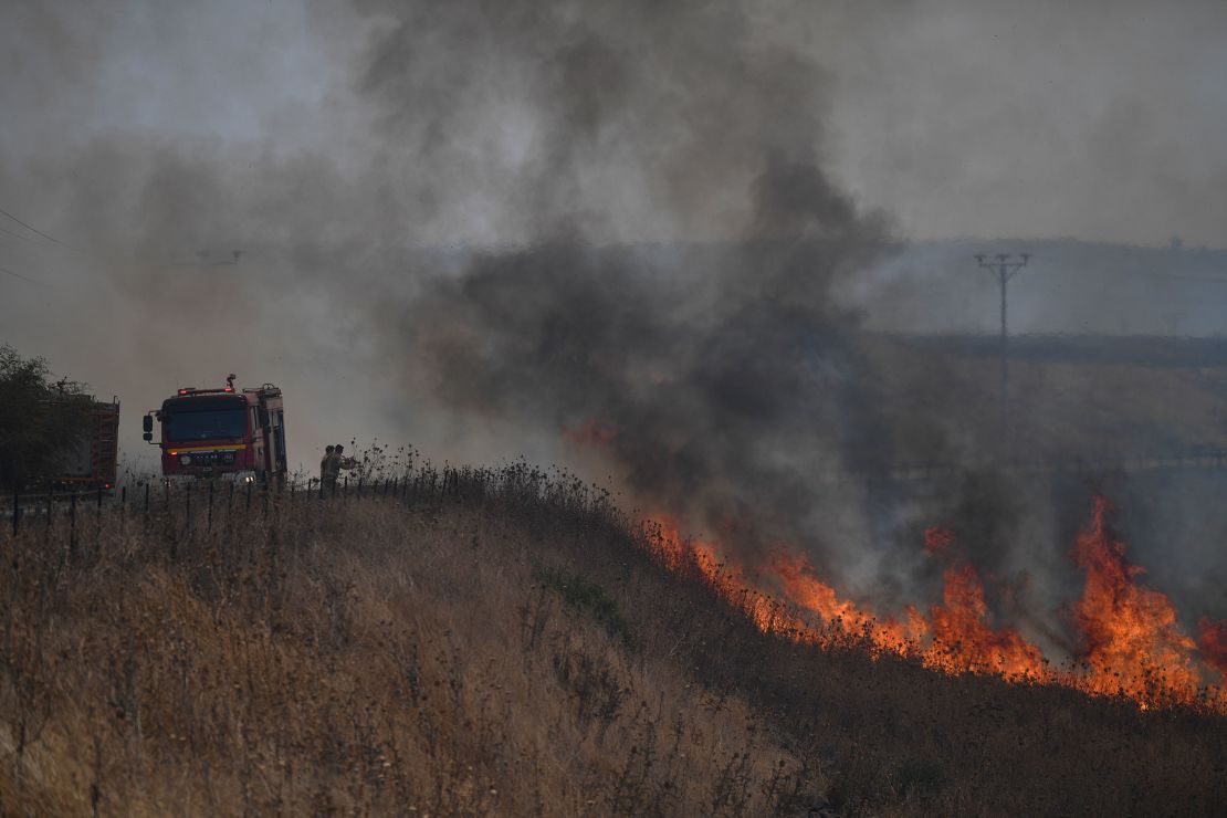 Firefighters work to extinguish a blaze following an attack from Hezbollah in the Israeli-controlled Golan Heights.