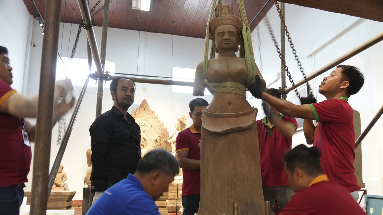 Museum staff members prepare an artifact returned from U.S to Cambodia, before an official ceremony at the Cambodian National Museum in Phnom Penh Cambodia, Thursday, July 4, 2024. Cambodia on Thursday officially organized a welcome ceremony for the arrival of more than a dozen rare Angkor era sculptures from New York's Metropolitan Museum of Art that were tied to an art dealer and collector accused of running a huge antiquities trafficking network out of Southeast Asia. (AP Photo/Heng Sinith)