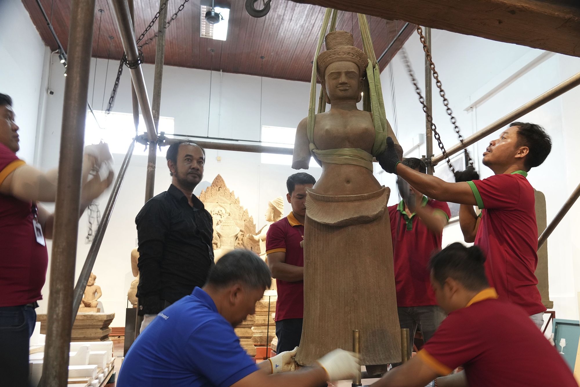 Museum staff members prepare an artifact returned from the U.S to Cambodia, before an official welcome ceremony at the Cambodian National Museum in Phnom Penh.