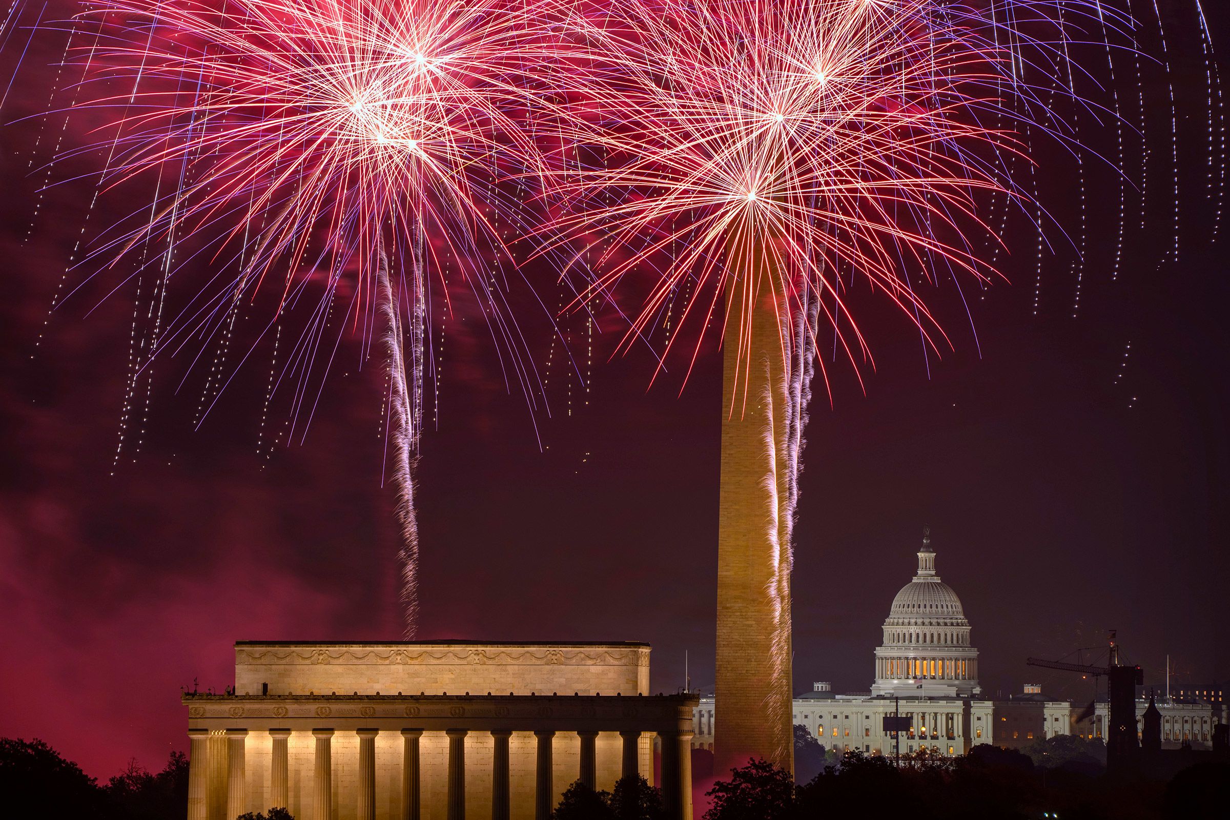 Fourth of July fireworks burst above the National Mall in Washington, DC.