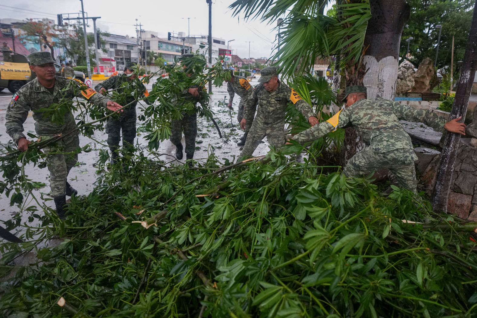 Soldiers collect branches felled by Hurricane Beryl in Tulum, Mexico, on Friday.