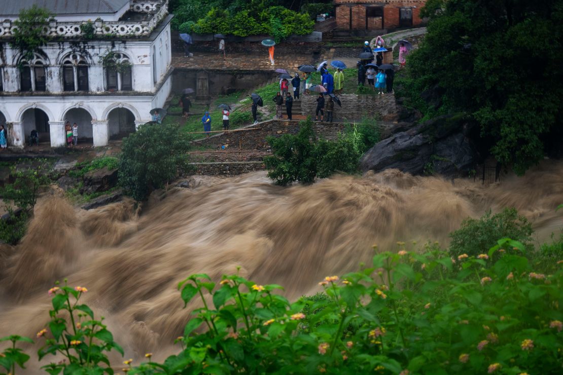 People watch the flooded Bagmati river in Kathmandu, Nepal, on July 6, 2024.