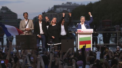 Far-left La France Insoumise - LFI - (France Unbowed) founder Jean-Luc Melenchon, right, clenches his fist with other party members after the second round of the legislative elections Sunday, July 7, 2024, in Paris. A coalition on the left that came together unexpectedly ahead of France's snap elections won the most parliamentary seats in the vote, according to polling projections Sunday. The surprise projections put President Emmanuel Macron's centrist alliance in second and the far right in third. (AP Photo/Thomas Padilla)