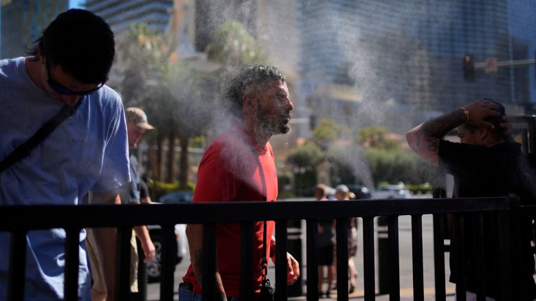 People cool off in misters along the Las Vegas Strip, Sunday, July 7, 2024.