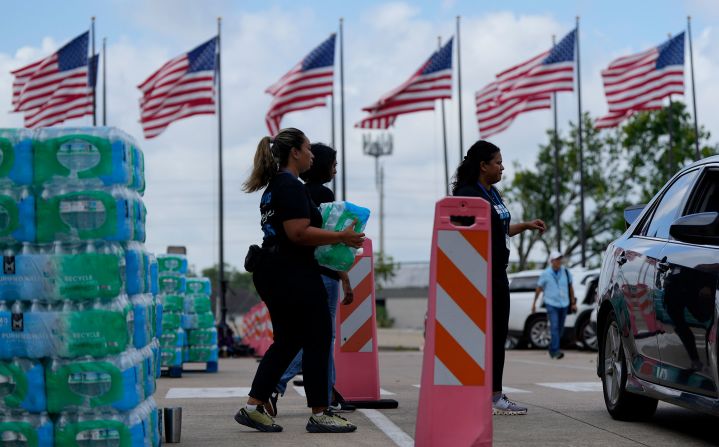 Staff at Lakewood Church hand out water at a cooling station in Houston on Tuesday.