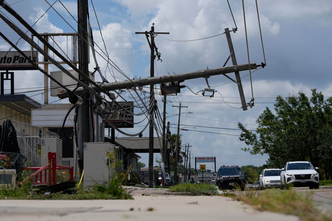 Traffic is directed around a downed power line in Houston, Texas, on Tuesday.