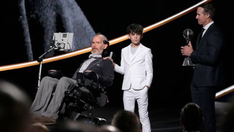 Steve Gleason, left, makes comments as he receives the Arthur Ashe Award for Courage, as his son Rivers, center, and Drew Brees, right, stand by at the ESPY awards on Thursday, July 11, 2024, at the Dolby Theatre in Los Angeles.