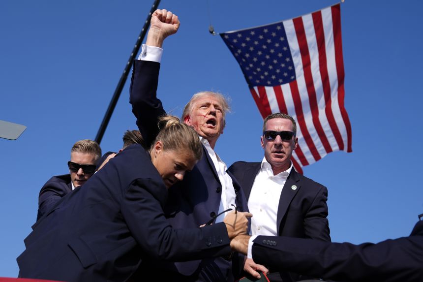 Donald Trump is surrounded by Secret Service agents at a campaign rally, Saturday, July 13, 2024, in Butler, Pennsylvania. (AP Photo/Evan Vucci)