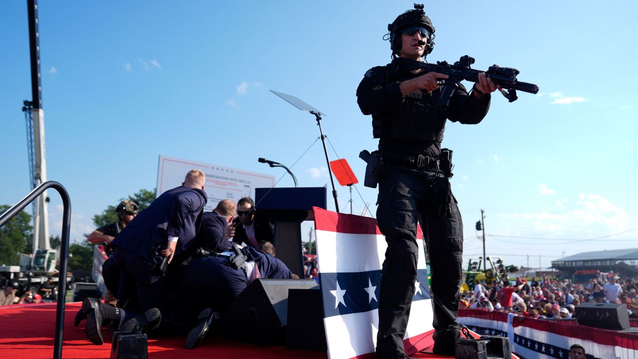 Republican presidential candidate former President Donald Trump is covered by U.S. Secret Service agents at a campaign rally, Saturday, July 13, 2024, in Butler, Pa. (AP Photo/Evan Vucci)