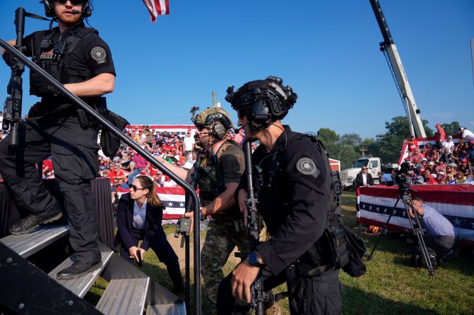 Secret Service agents rush the stage immediately after the shooting.