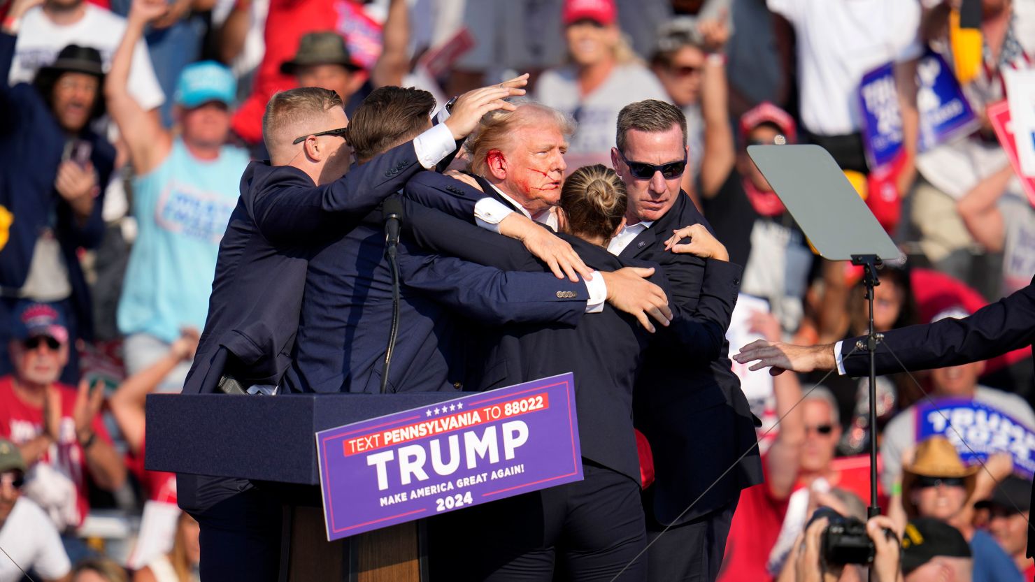 Former President Donald Trump is helped off the stage at a campaign event in Butler, Pennsylvania, on Saturday, July 13.