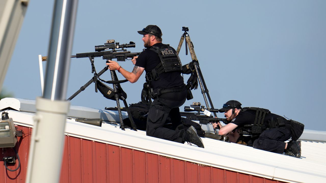 Police snipers return fire after shots were fired while Republican presidential candidate former President Donald Trump was speaking at a campaign event in Butler, Pa., on Saturday, July 13, 2024. (AP Photo/Gene J. Puskar)