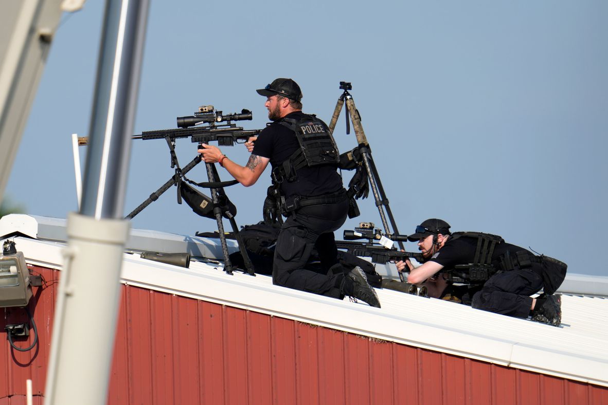 Police snipers are seen above the rally. A law enforcement source and a police officer at the scene told CNN <a  target="_top" href="/newspapers?url=https://www.cnn.com/politics/live-news/election-biden-trump-07-13-24#h_2213990564fb532dab0780858b3ec1be">the shooter was positioned on a building rooftop just outside the rally venue</a>.