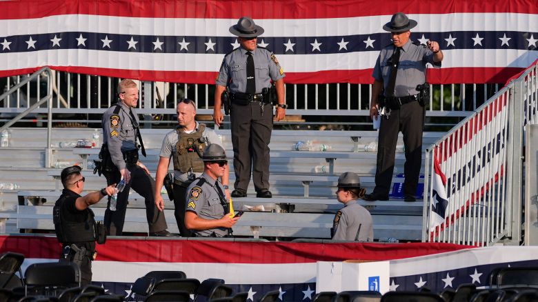 Law enforcement officers work at the campaign rally site for Republican presidential candidate former President Donald Trump is empty and littered with debris Saturday, July 13, 2024, in Butler, Pa. (AP Photo/Evan Vucci)