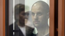 Wall Street Journal reporter Evan Gershkovich stands listening to the verdict in a glass cage of a courtroom inside the building of "Palace of justice," in Yekaterinburg, Russia, on Friday, July 19, 2024. A Russian court convicted Gershkovich on espionage charges that his employer and the U.S. have rejected as fabricated. He was sentenced to 16 years in prison after a secretive and rapid trial in the country's highly politicized legal system. (AP Photo/Dmitri Lovetsky)