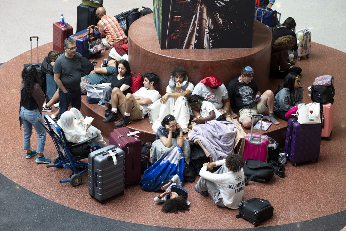 Passengers wait on flights at Hartsfield Jackson International Airport in Atlanta, Friday, July 19, 2024, as a major internet outage disrupts flights, banks, media outlets and companies across the world.