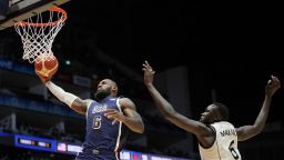 United States' forward LeBron James scores as South Sudan's center Khaman Maluach attempted top defend during an exhibition basketball game between the United States and South Sudan, at the o2 Arena in London, on July 20, 2024.