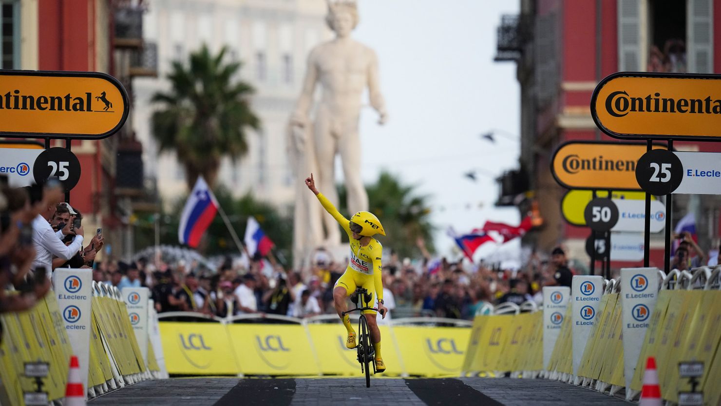 Tour de France winner Slovenia's Tadej Pogacar, wearing the overall leader's yellow jersey, celebrates as he crosses the finish line of the twenty-first stage of the Tour de France cycling race, an individual time trial over 33.7 kilometers (20.9 miles) with start in Monaco and finish in Nice, France, Sunday, July 21, 2024. (AP Photo/Daniel Cole)