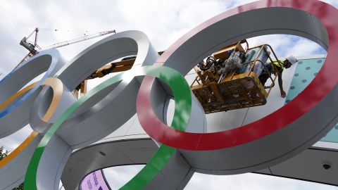 A worker puts on the finishing touches on a sign outside a venue ahead of the 2024 Summer Olympics, Monday, July 22, 2024, in Paris.