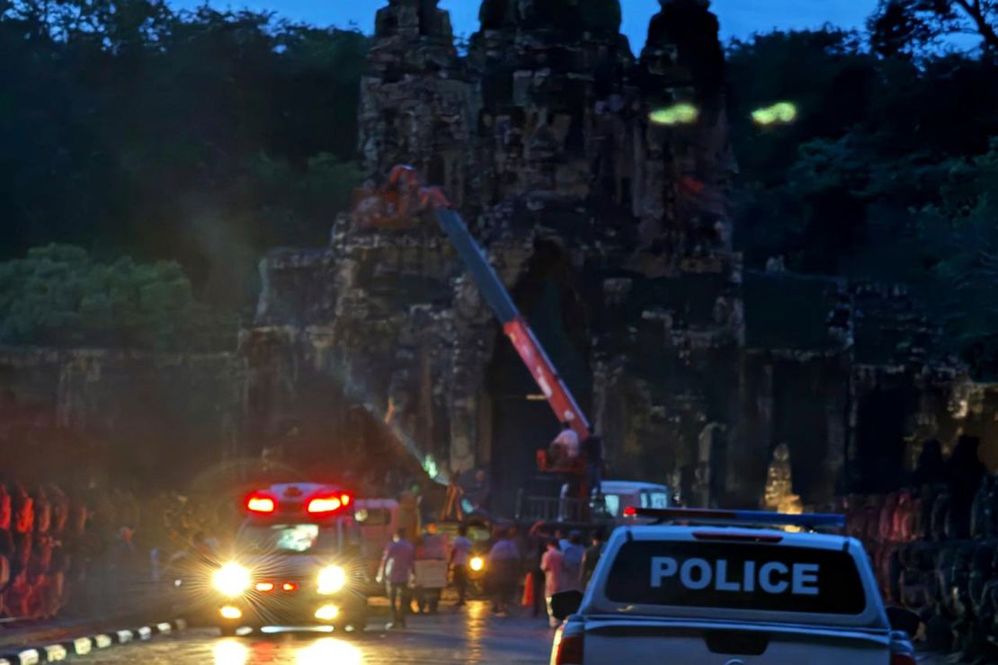 Police respond after a storm toppled a tree, killing one person and damaging statues at the Angkor archaeological site in Siem Reap, Cambodia, on Tuesday, July 23, 2024.