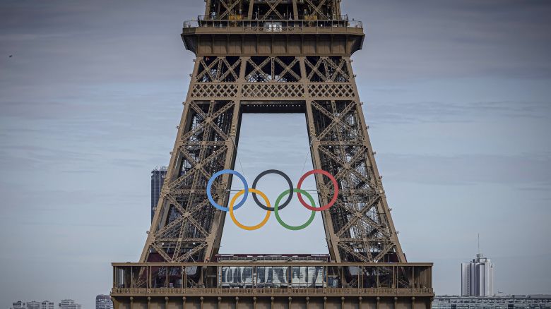 FILE - The Olympic rings are seen on the Eiffel Tower, Sunday, July 14, 2024, in Paris. Five players on Australia's women's water polo team for the Paris Olympics have tested positive for COVID-19. (AP Photo/Aurelien Morissard, File)