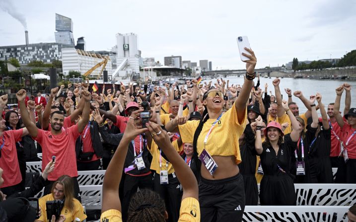 German basketball player Satou Sabally takes a selfie with other athletes on a boat during the Parade of Nations.