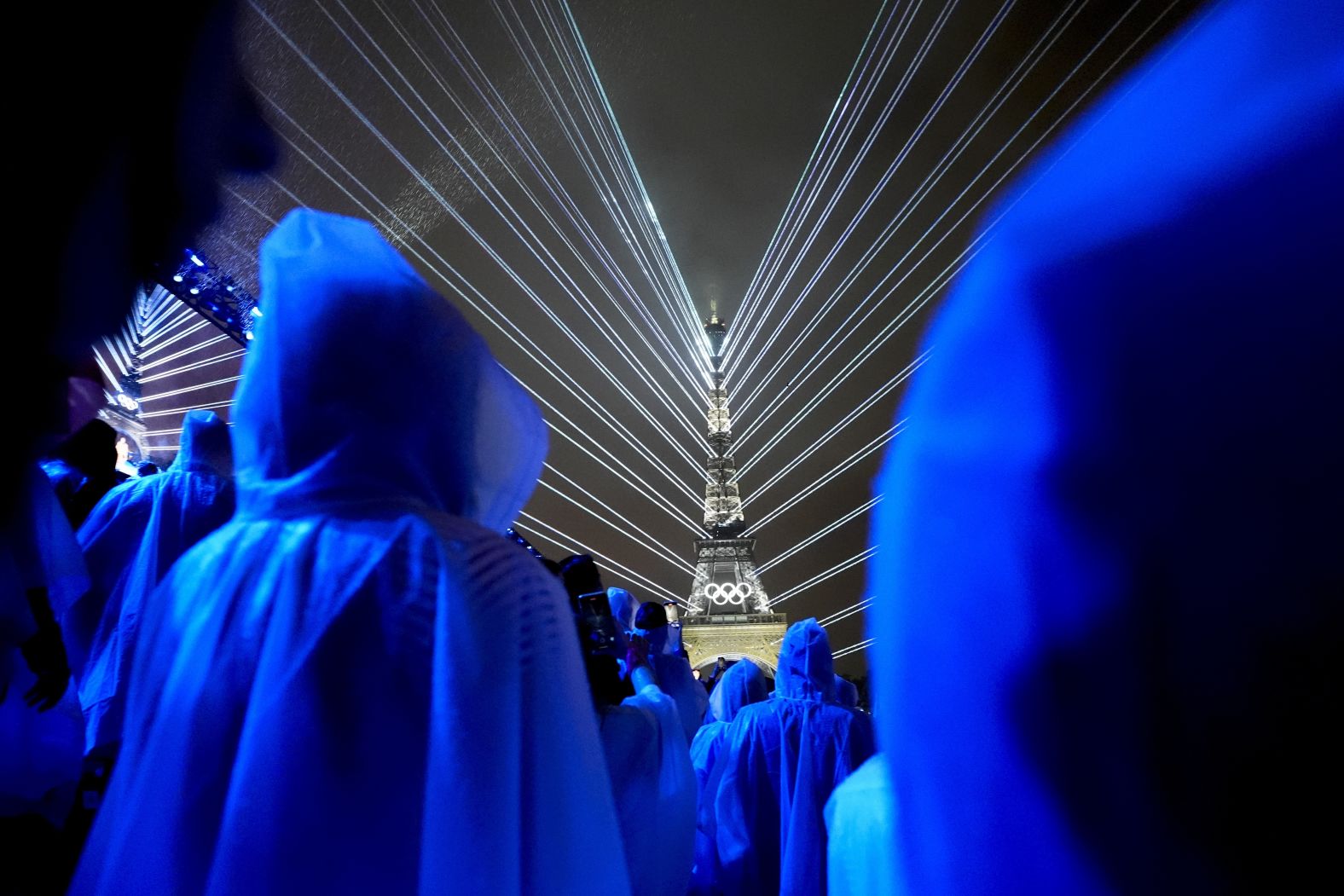 Flashes of lights illuminate the Eiffel Tower.