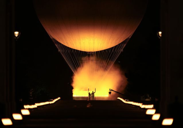 French judoka Teddy Riner, right, and former French track star Marie-José Pérec watch the <a >Olympic cauldron</a> rise in a hot-air balloon after they lit it at the end of the opening ceremony in Paris on Friday, July 26. The first hot-air balloon flight was performed in France in 1783.