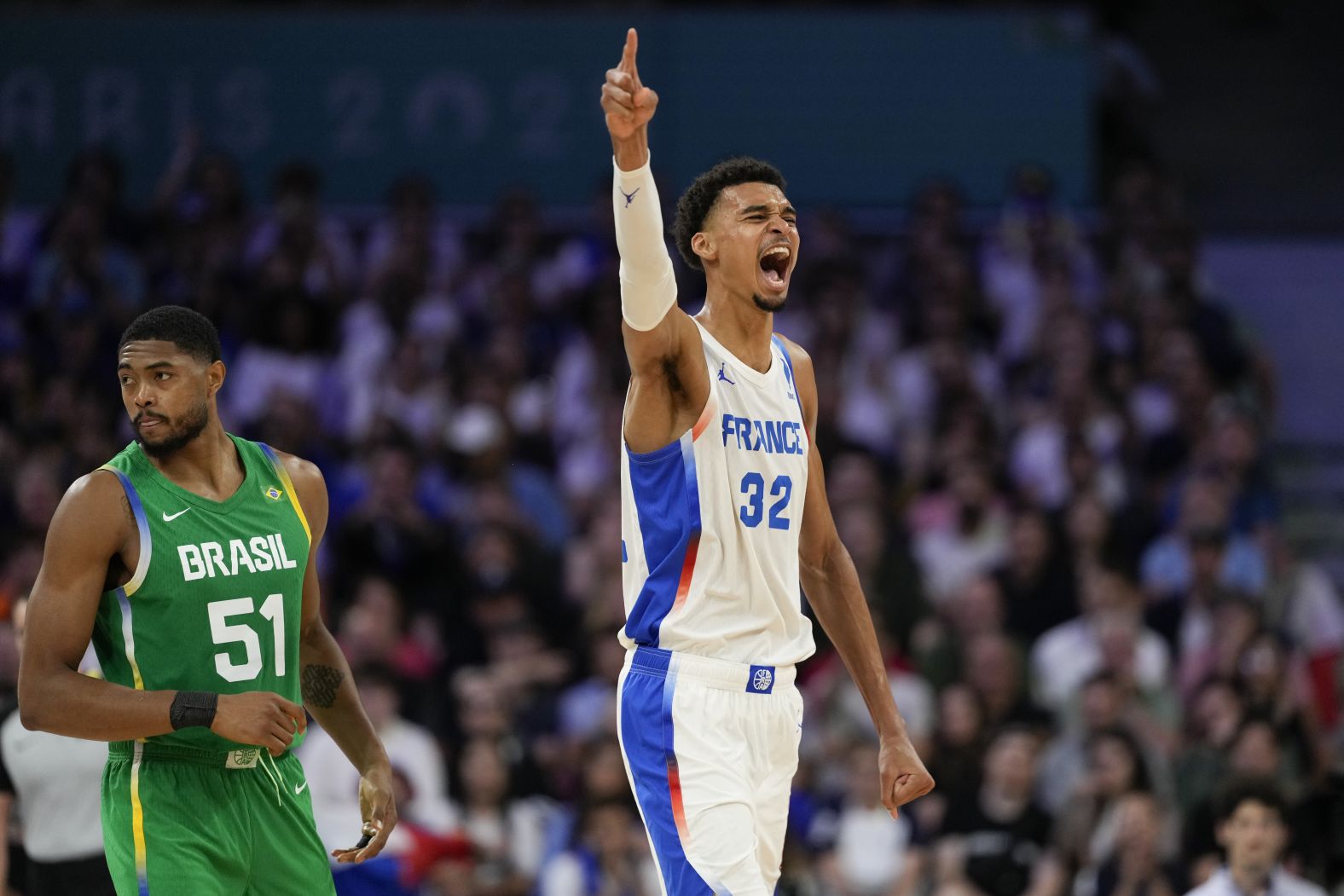 French basketball superstar Victor Wembanyama celebrates a Brazil turnover during the teams' opening game on July 27. Wembanyama had 19 points, nine rebounds, two assists, four steals and three blocks as <a >France won 78-66</a>.