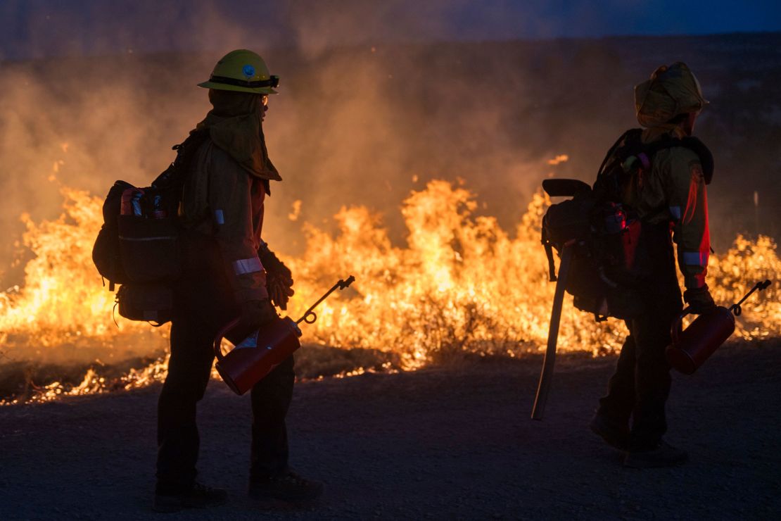 Fire crews light a burn operation to slow the Park Fire near Dales, California, on July 29.