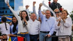 Opposition leader Maria Corina Machado, left, and opposition candidate Edmundo Gonzalez hold up vote tally sheets from the top of a truck during a protest against the official presidential election results declaring President Nicolas Maduro the winner in Caracas, Venezuela, on Tuesday, July 30, 2024, two days after the election. (AP Photo/Cristian Hernandez)