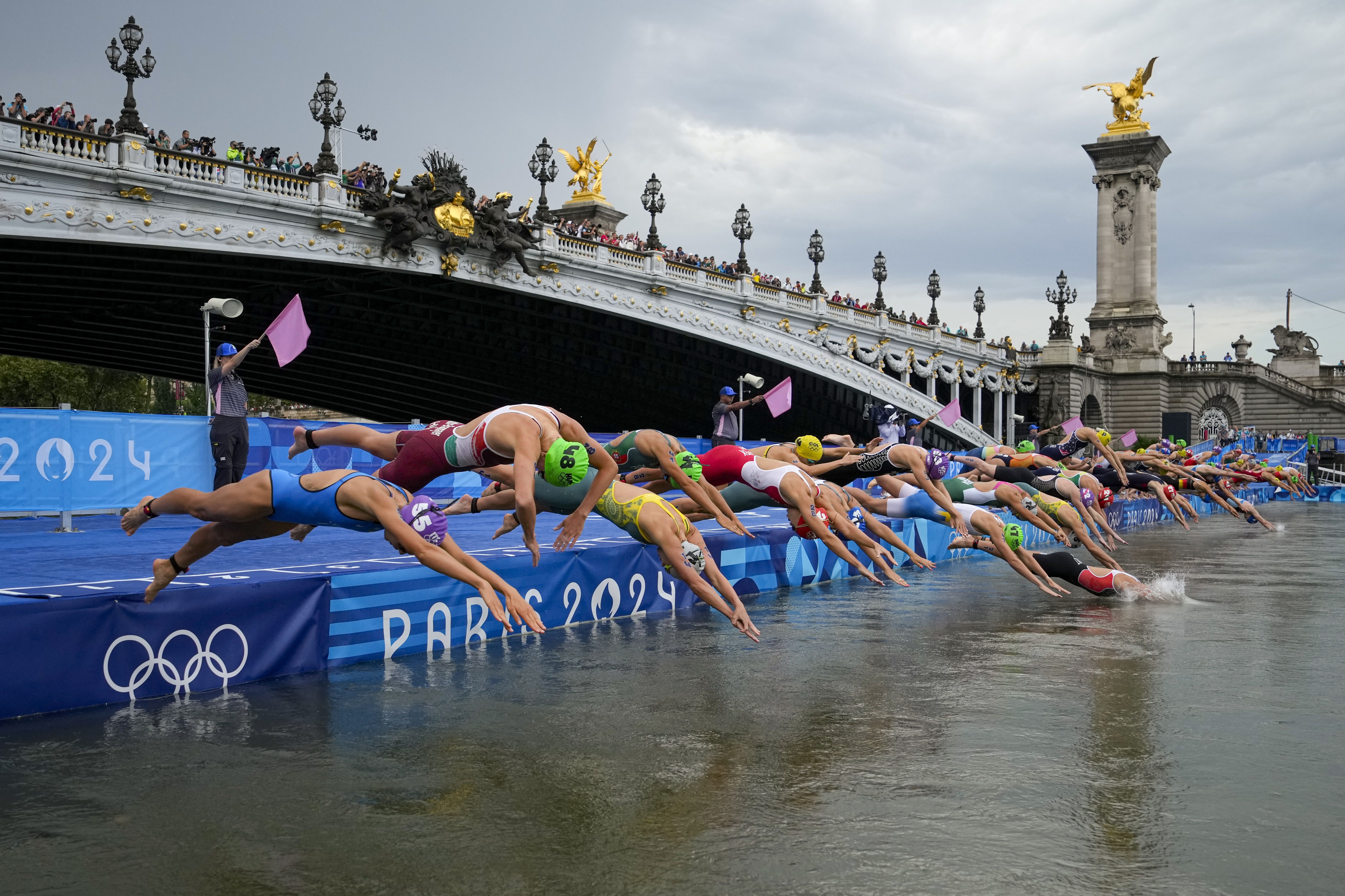 Competitors dive into the Seine River in Paris during the women's Olympic triathlon on July 31. <a href="https://www.cnn.com/2024/07/29/sport/seine-pollution-olympics-triathlon-postponed-intl-hnk/index.html">Water quality concerns</a> had postponed the men's triathlon by a day, but it was held on the same day as the women's.