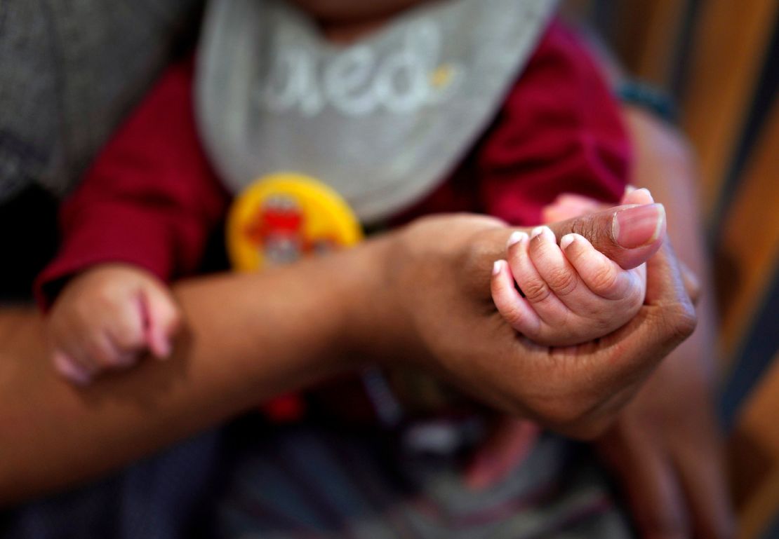 Jasmine Herriot, a former Mary Shelter resident, holds her infant son's hand, Friday, Jan. 5, 2024, in Fredericksburg, Virginia.  In the two years since the Supreme Court overturned Roe v. Wade and overturned federal abortion rights, there has been a nationwide expansion of maternity homes.  Today there are more than 450 houses in the US, many of them faith-based.