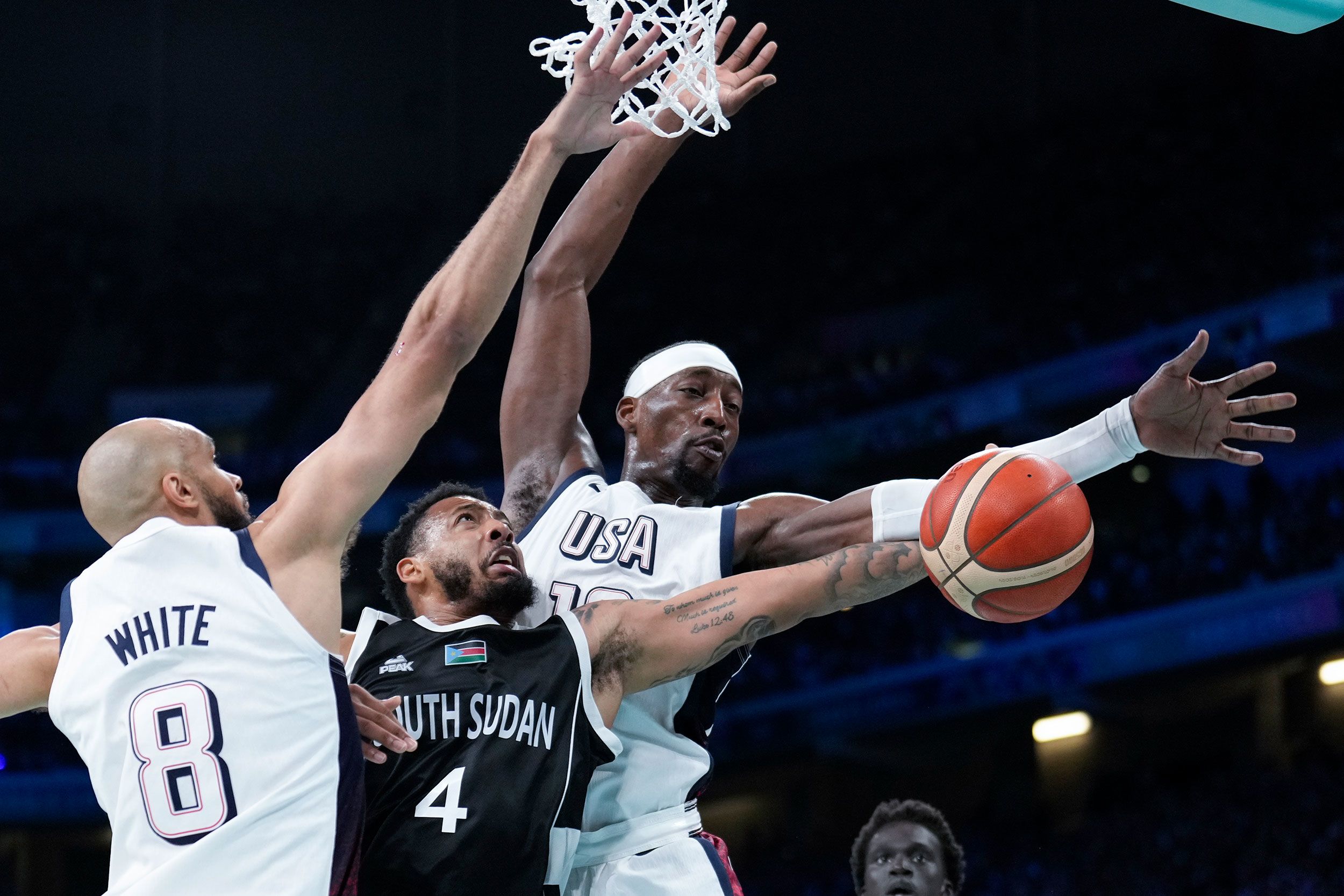 South Sudan's Carlik Jones is defended by the United States' Derrick White and Bam Adebayo on July 31. Team USA won 103-86.