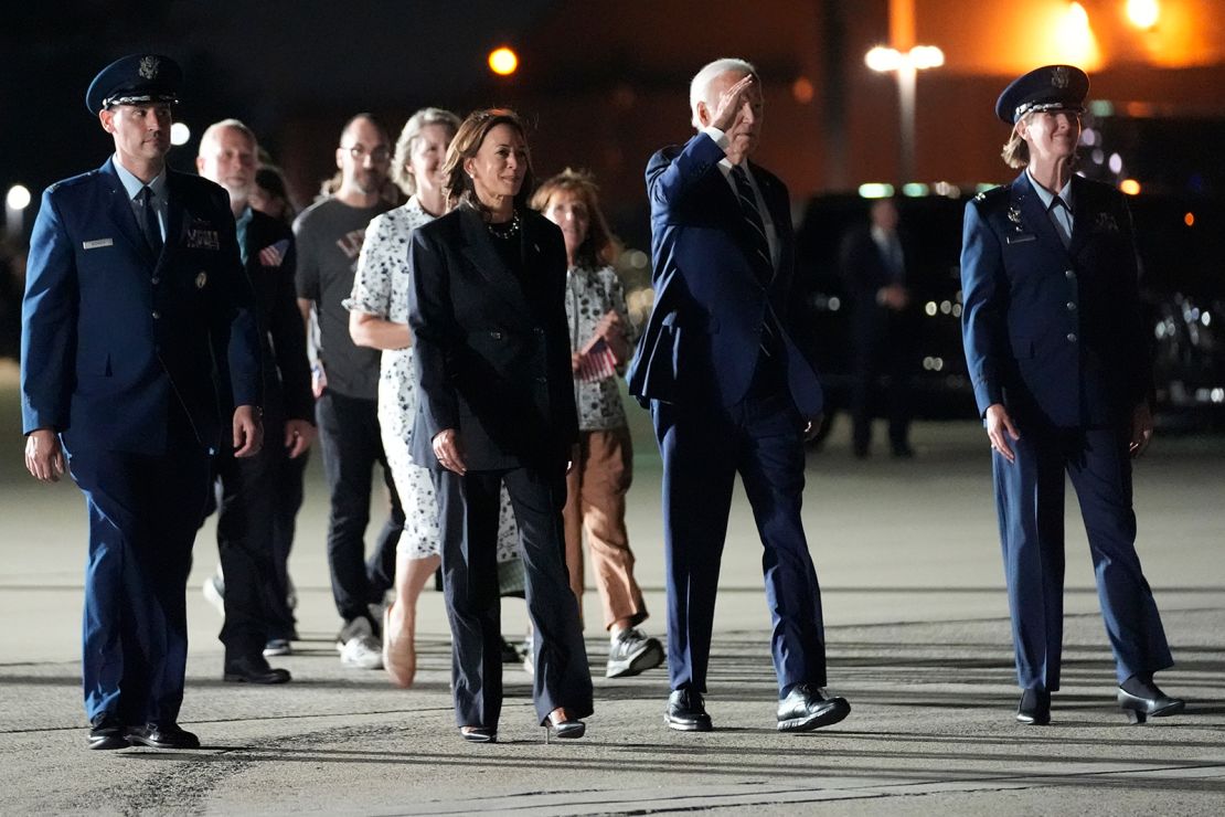 President Joe Biden and Vice President Kamala Harris walk with family members of the returning Americans to greet them at Joint Base Andrews.