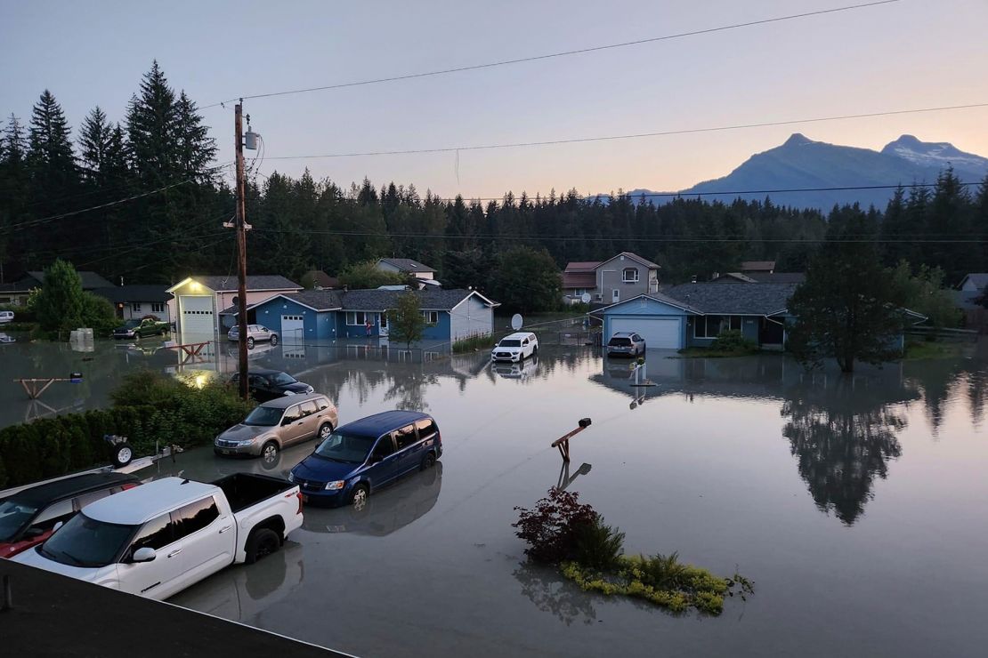 Water in a neighborhood in Juneau, Alaska, Tuesday, Aug. 6, 2024, following an outburst of flooding from a lake dammed by the Mendenhall Glacier.