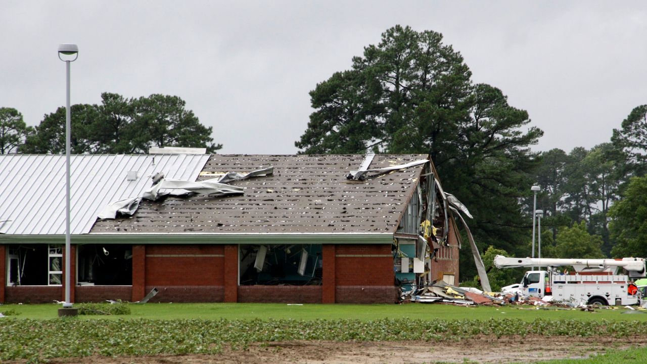 Parts of Springfield Middle School lay on the ground after being ripped off by a tornado, spawned by Tropical Storm Debby, in Lucama, N.C., Thursday, Aug. 8, 2024. (AP Photo/Makiya Seminera)