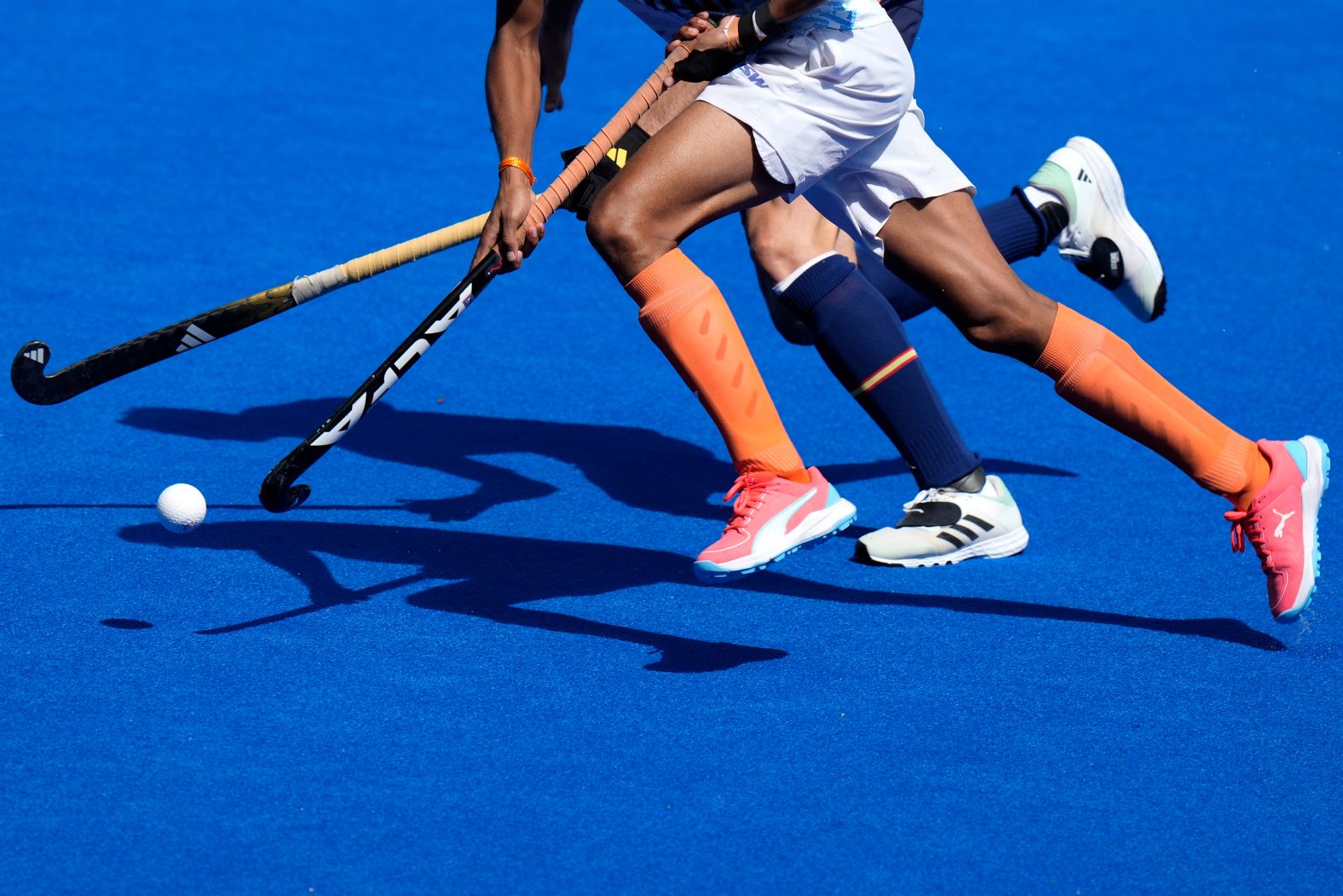 India's Raj Kumar Pal, front, runs with Spain's Marc Vizcaino during a field hockey match on August 8. India won 2-1. to take the bronze medal.