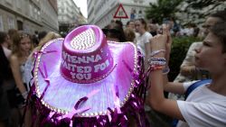 A person wears a purple head as Swifties gather in the city centre in Vienna on Thursday, Aug.8, 2024. Organizers of three Taylor Swift concerts in the stadium in Vienna this week called them off on Wednesday after officials announced arrests over an apparent plot to launch an attack on an event in the Vienna area such as the concerts. (AP Photo/Heinz-Peter Bader)