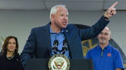 Democratic vice presidential nominee Minnesota Gov. Tim Walz, with Democratic presidential nominee Vice President Kamala Harris, left, and UAW President Shawn Fain, speaks at a campaign rally at UAW Local 900, Thursday, August 8, 2024, in Wayne, Mich. (AP Photo/Julia Nikhinson)