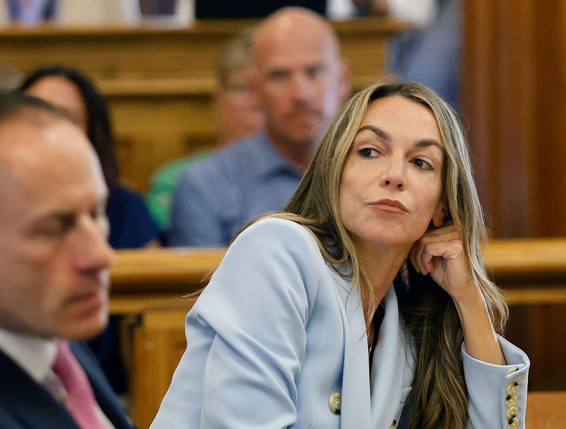 Karen Read listens to her attorney, Martin Weinberg, argue in favor of dismissing two charges against her in Norfolk Superior Court on August 9, 2024.