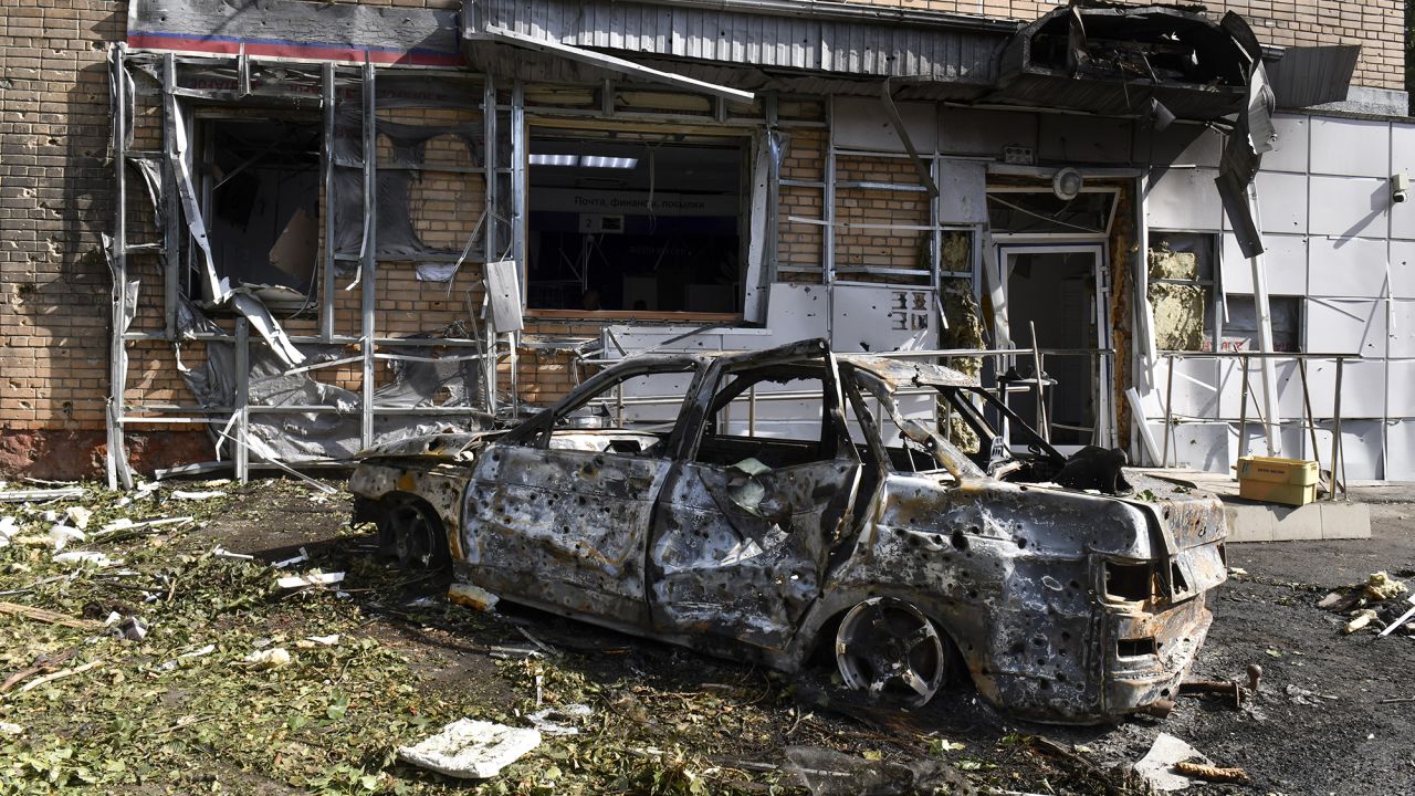 A burned car is seen in front of an apartment building damaged after shelling by the Ukrainian side in Kursk, Russia, on Sunday, August 11, 2024.