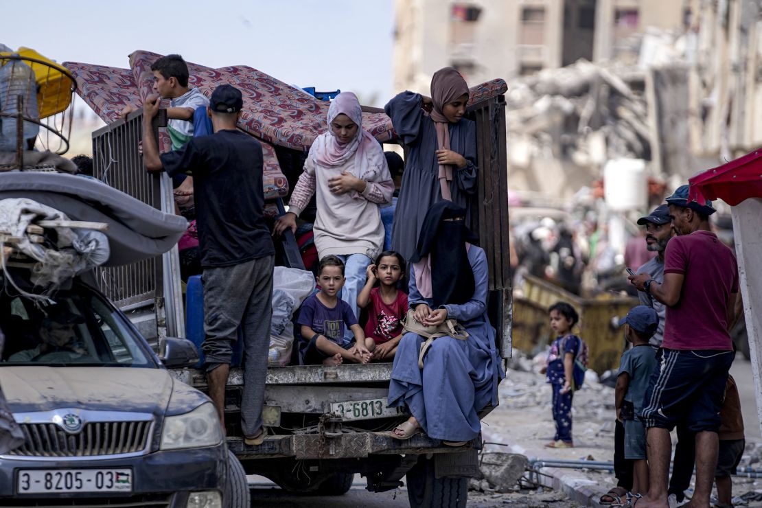 Displaced Palestinians flee from Hamad City following an evacuation order by the Israeli army to leave parts of the southern area of Khan Younis, on Sunday, August 11.